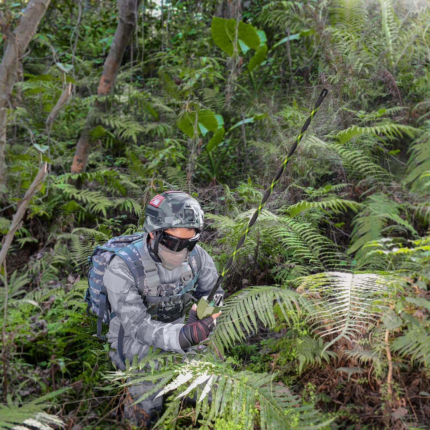 Tactical operator in the woods with the Bingfu long antenna folded and secured with the included Velcro strap.